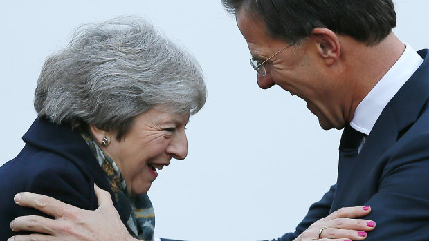 British Prime Minister Theresa May is greeted by Dutch Prime Minister Mark Rutte upon her arrival in The Hague, Netherlands, on  December 11.