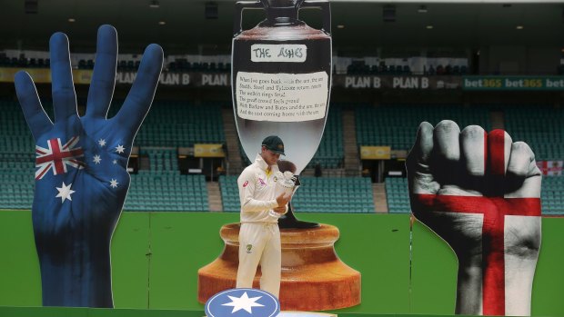 How the mighty have fallen: Steve Smith accepts the Ashes in front of a fairly garish backdrop.