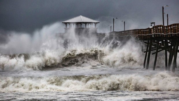 Waves slam the Pier House Restaurant in Atlantic Beach, NC, on Thursday.