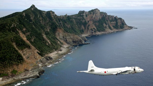 Japan Maritime Self-Defence Force P-3C Orion surveillance plane flies over the disputed islands, called the Senkaku in Japan and Diaoyu in China.