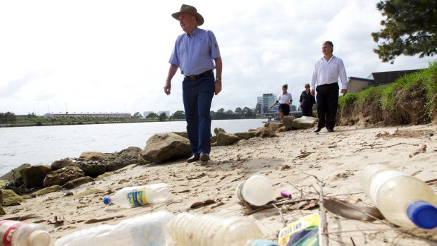 Ian Kiernan, left, looks at the amount of rubbish washed up on the banks of the Cook River in Wolli Creek in 2013. 