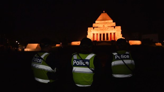 Police observe Anzac Day dawn service at the Shrine of Remembrance, Melbourne. 