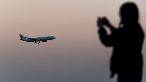 A Cathay Dragon aircraft, operated by Cathay Pacific Airways, prepares to land at Hong Kong International Airport.