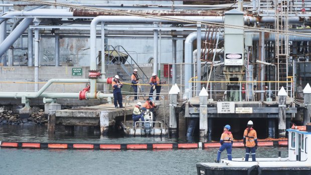 Workers at Viva's Gore Bay storage depot. after a spill in Sydney Harbour at the end of 2016.