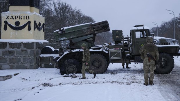 Ukrainian servicemen walk by a deactivated Russian military multiple rocket launcher on the outskirts of Kharkiv, Ukraine.