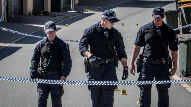 ACT police officers at the scene of the alleged murder in Gungahlin. 