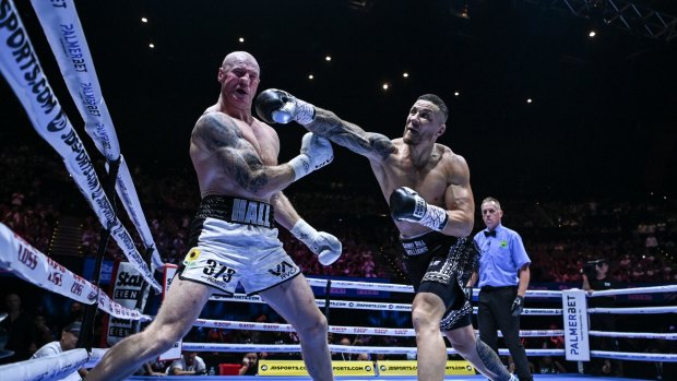 All Black and Sydney Roosters player Sonny Bill Williams vs former AFL Sydney Swans player Barry Hall exchange punches during their fight at Aware Super Theatre in Sydney.