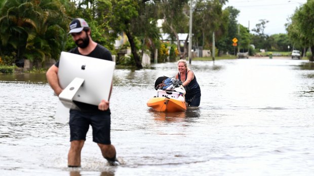 Local residents salvage items from their flood-affected home in the suburb of Hermit Park in Townsville on February 6, 2019. 