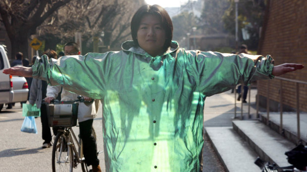 Graduate student Kazutoshi Obana demonstrates optical camouflage technology at Tokyo University in 2003. 