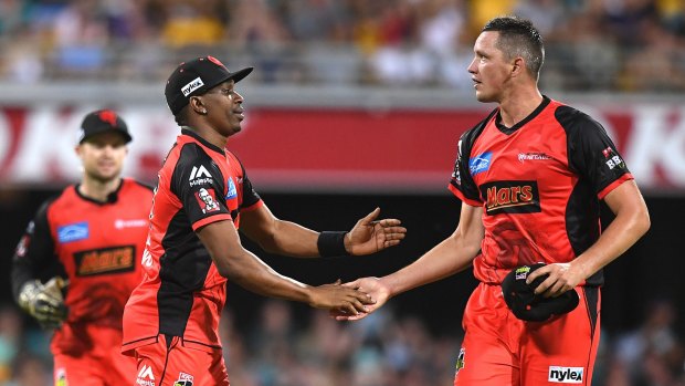 Job well done: Renegades Dwayne Bravo (left) and Chris Tremain celebrate after getting the better of Brisbane at the Gabba during last year's BBL season.