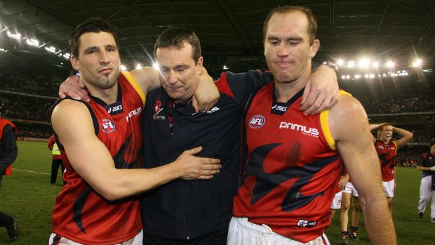 Russell Robertson and then Melbourne captain David Neitz walk off the ground with former coach Neale Daniher after his last game in 2007.