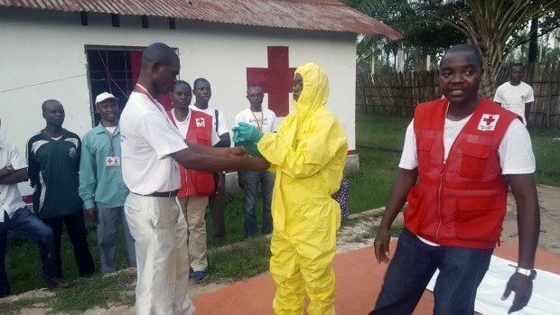 A Red Cross team dons protective clothing before heading out to look for suspected victims of Ebola, in Mbandaka. 
