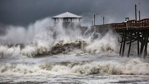 Waves slam the Pier House Restaurant in Atlantic Beach, NC, on Thursday.