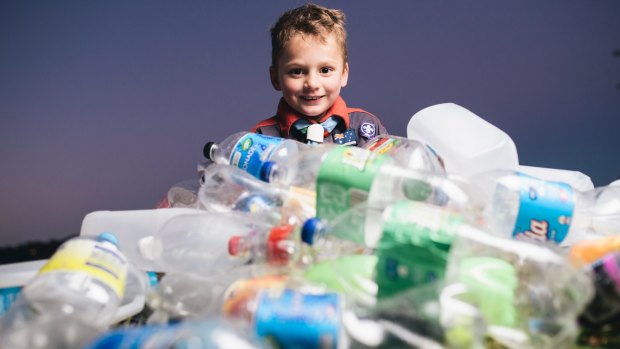 Scout Oliver Georgiou, 6, with a pile of bottles and cans bound for the container deposit scheme.