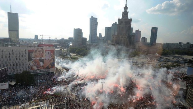 Warsaw residents stand with national flags and flares to observe a minute of silence for the fighters and victims of the 1944 Warsaw Rising against the Nazi German occupiers, on the 74th anniversary of the revolt last week.