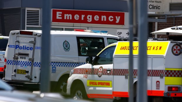 Police and ambulance vehicles outside Nepean Hospital's emergency area.  