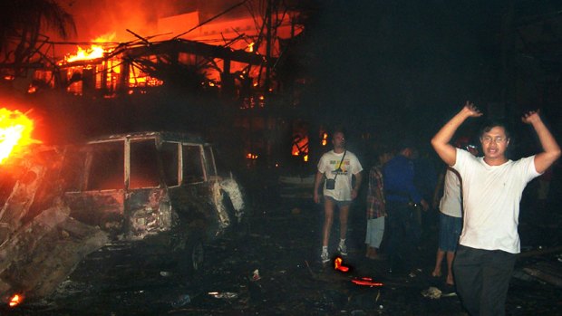 October 13, 2002: residents and tourists evacuate the scene of the Bali bombing.