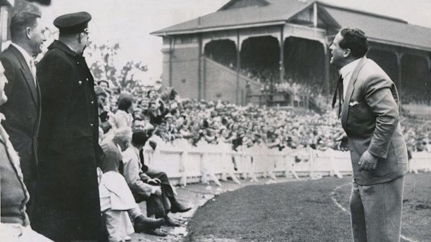 Coach Allan Killigrew urges St Kilda supporters on at the Junction Oval in 1956.