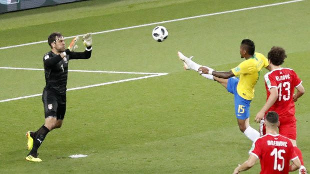 Brazil's Paulinho, right, scores the opening goal during the group E match between Serbia and Brazil.