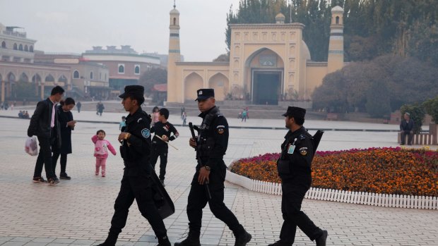 Security personnel on patrol outside a mosque frequented by Uighurs in Xinjiang.