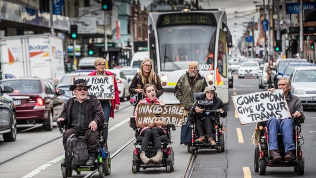 Brian Caccianiga (black hat) and fellow disability advocates blocked trams on Sydney Road in Brunswick earlier this year.