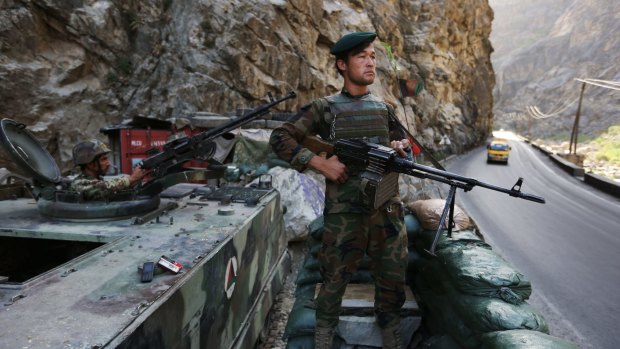 An Afghan soldier guards a checkpoint on the Kabul-Jalalabad highway on the outskirts of Kabul, Afghanistan. 