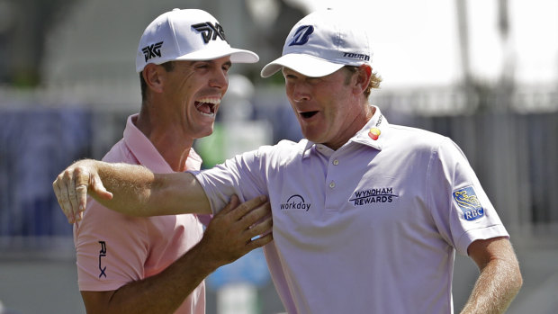 You beauty: Snedeker celebrates with playing partner Billy Horschel after making birdie on the final hole.