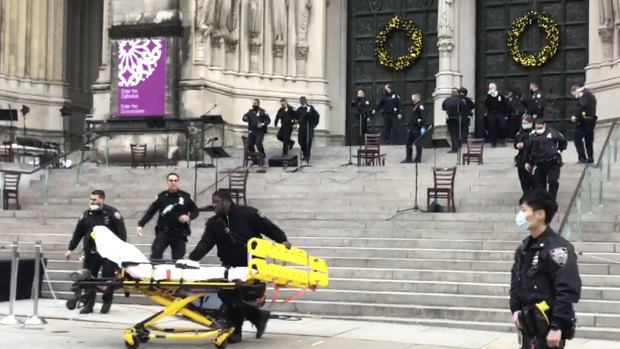 Emergency medical personnel pull a stretcher up to the scene of the shooting at the Cathedral Church of St John the Divine in New York.