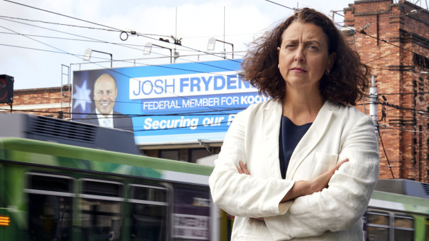 Independent for Kooyong Dr Monique Ryan at Camberwell Junction in Melbourne, in front of billboards of Josh Frydenberg.