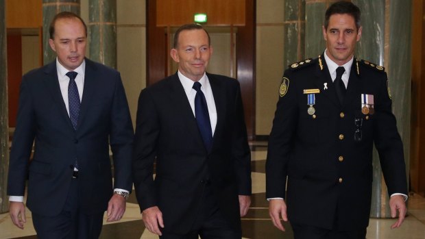Then prime minister Tony Abbott and his immigration minister Peter Dutton at the swearing-in ceremony of inaugural Border Force commissioner Roman Quaedvlieg in 2015.