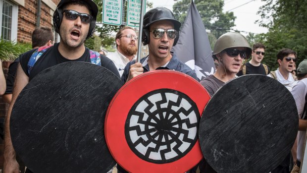 A white supremacist with the black sun symbol on his shield in Charlottesville, Virginia, in 2017. Christchurch shooter Brenton Tarrant also used this symbol, but Harnwell rejects the idea that talk of culture wars fuels such extremism.