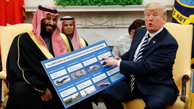 March 2018: President Trump holds a chart highlighting $US12.5 billion in arms sales to Saudi Arabia during a meeting with Saudi Crown Prince Mohammed bin Salman in the Oval Office.