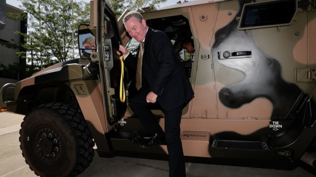 Then defence industry minister Christopher Pyne in a Hawkei earlier this year.