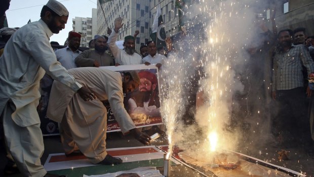 People celebrate the shooting down of Indian planes by Pakistani forces with fireworks in Karachi, Pakistan, on Wednesday.