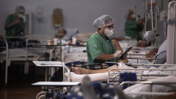 A healthcare worker treats a COVID-19 infected patient in Brazil.