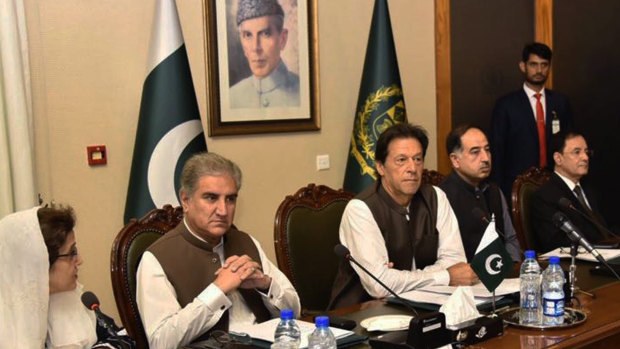 Pakistani Prime Minister Imran Khan, center, attends a briefing at the Foreign Ministry in Islamabad.