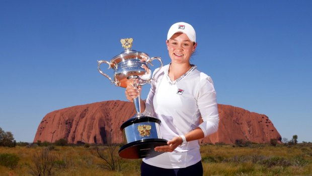 Ashleigh Barty poses with the Daphne Akhurst Memorial Cup as she visits Uluru in February.