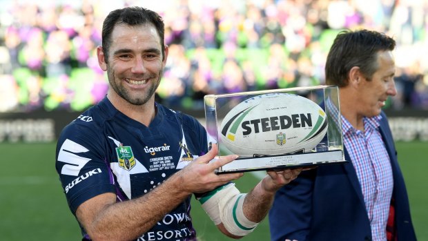 Melbourne milestone: Cam Smith holds his award after game 350, with coach Craig Bellamy in the background.