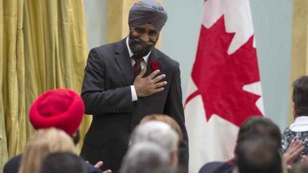 Sikh achievement: Harjit Singh Sajjan reacts after being sworn in as Canada's defence minister in Ottawa in 2015. Seated in the red turban is Navdeep Singh Bains, who was sworn in as science and innovation minister on the same day.
