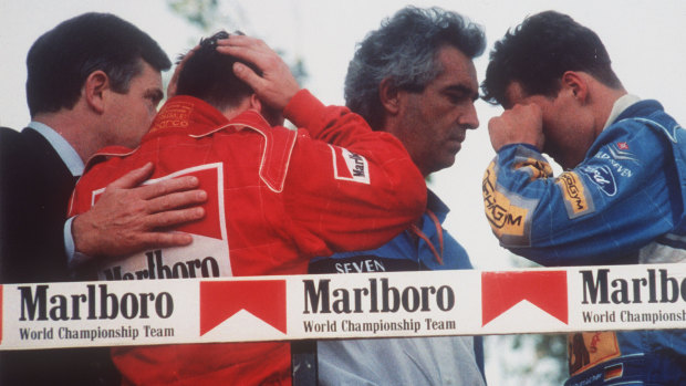 Italy’s Nicola Larini and Germany’s Michael Schumacher react to news that Brazilian driver Ayrton Senna was in critical condition at a Bologna hospital after a crash in the 1994 San Marino Grand Prix.