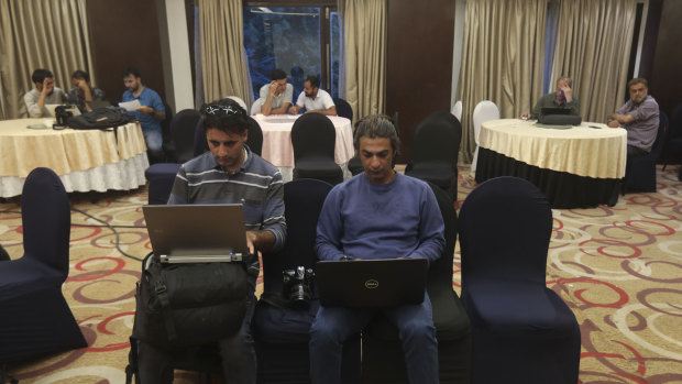 Journalists work inside a media centre set up by Jammu and Kashmir authorities in Srinagar, Indian controlled Kashmir.