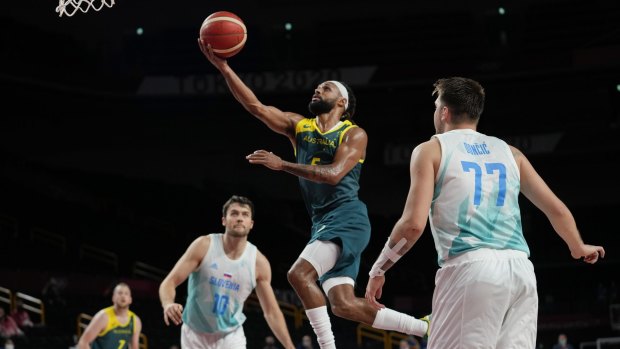 Hoop dreams: Patty Mills breezes past Luka Doncic (77) and Mike Tobey (10) for an easy basket.