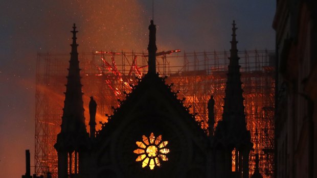 Flames and smoke rise from Notre-Dame Cathedral as it burns in Paris.