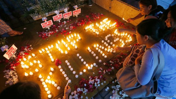Human rights activists light candles in Quezon City for the victims of extra-judicial killings.