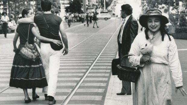 Mirka Mora, in paint-spattered clothes, walks along the Bourke Street Mall, 1981.