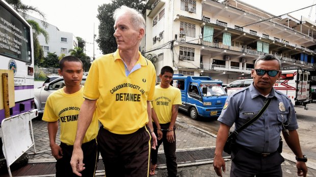 Peter Scully (second from left) arrives at the Cagayan De Oro court in September. 