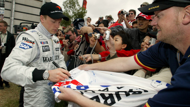 Early days: Driving for McLaren in 2004, Kimi Raikkonen signs autographs for fans at the Albert Park circuit prior to the start of the Australian Formula One Grand Prix in Melbourne.
