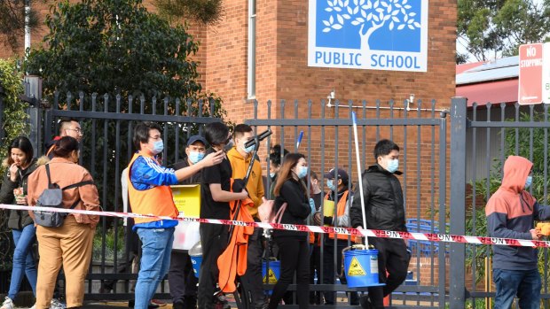 Cleaners leave South Coogee Public School after deep cleaning due to a COVID-19 outbreak at the school. 