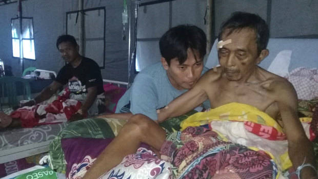 Patients are treated at a makeshift hospital in Poso, Central Sulawesi, Indonesia, on Saturday.