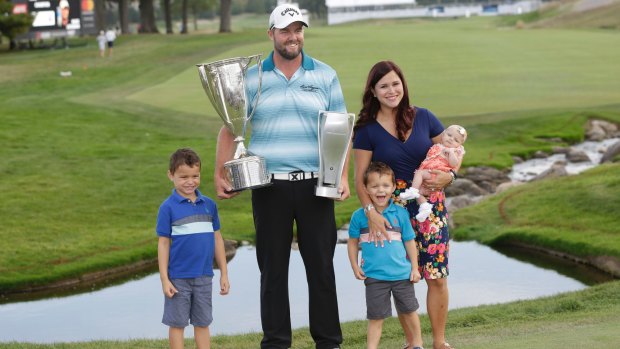 Marc Leishman and his family pose with the Wadley Cup, the BMW Championship trophy.